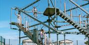 Group of friends climbing the Crow's Nest High Ropes at Richardson's Family Entertainment Centre